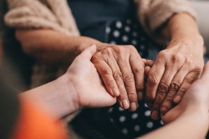 Granny and granddaughter talking and holding hands