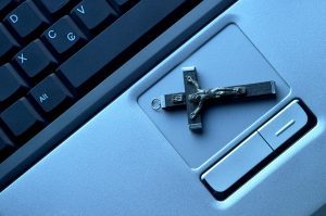 Cross on top of a laptop track pad