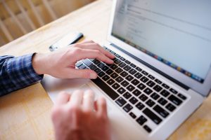 Closeup of businessman is keyboarding on laptop